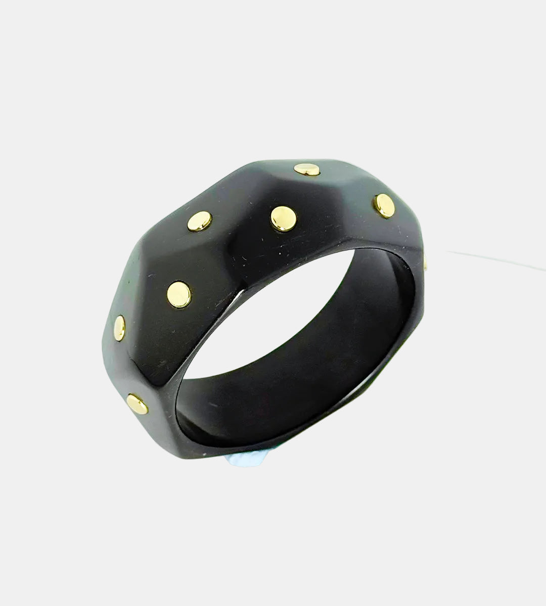 Black ring with gold accents on a white background